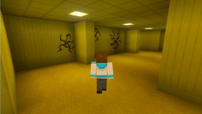 マイクラ統合版のBACKROOMS Add-On。黄色い壁に黒い模様が描かれたロビーをプレイヤーが探索している様子