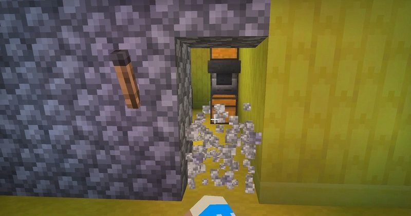 マイクラ統合版BACKROOMS Add-Onで、消えたたいまつの近くにある丸石の壁を壊し、隠し拠点を発見した様子